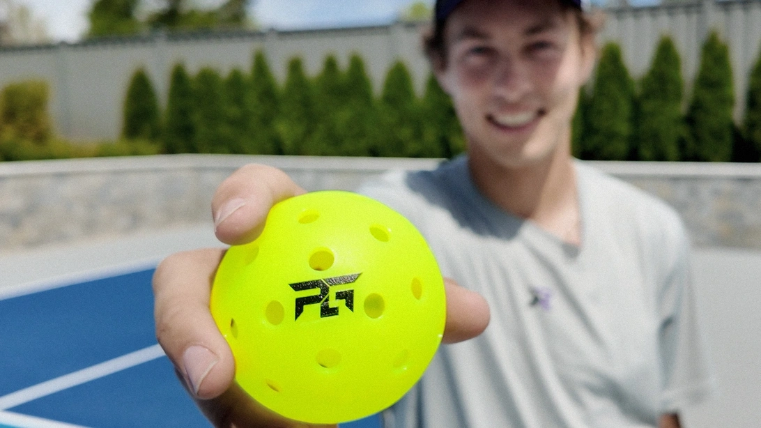 Connor Garnett holding a yellow pickleball.